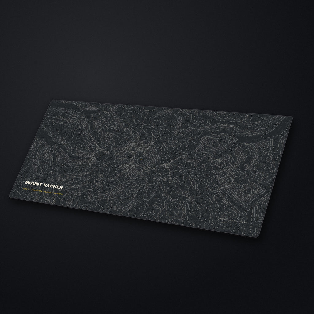 Mount Rainier Topo Desk Mat at an angle on a stone desk