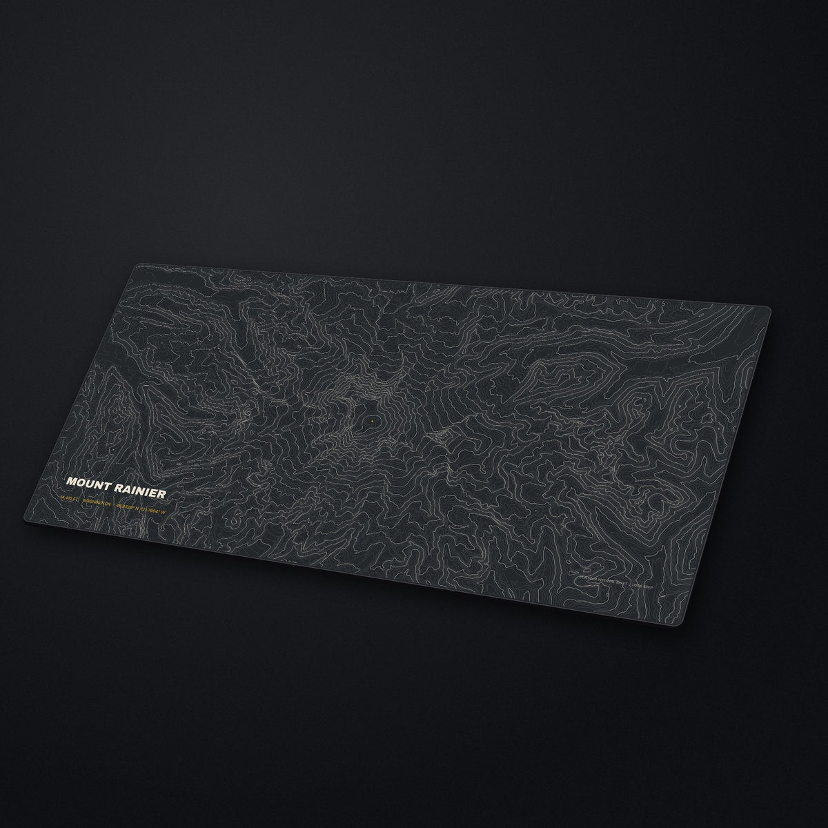 Mount Rainier Topo Desk Mat at an angle on a stone desk