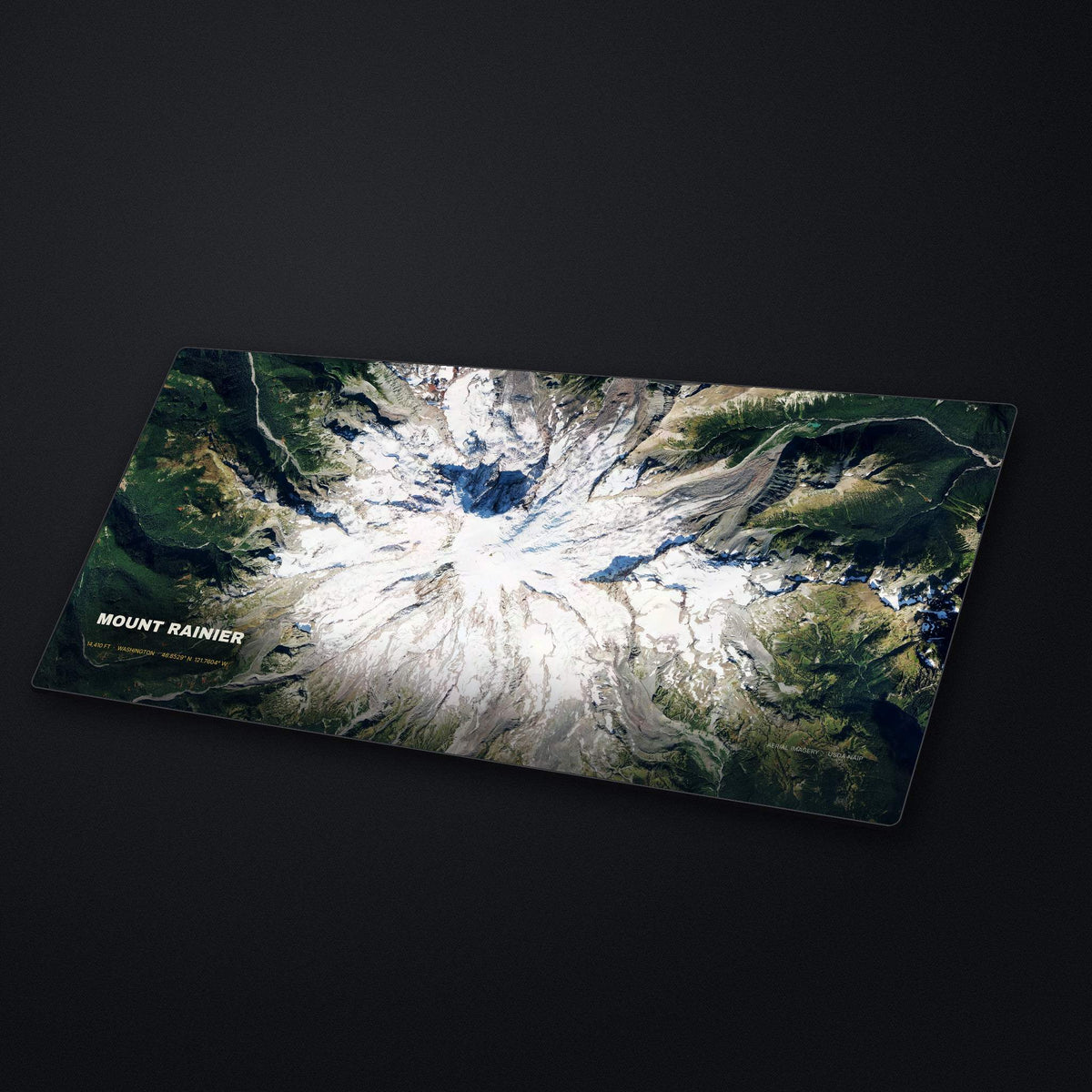Mount Rainier Satellite Desk Mat at an angle on a stone desk