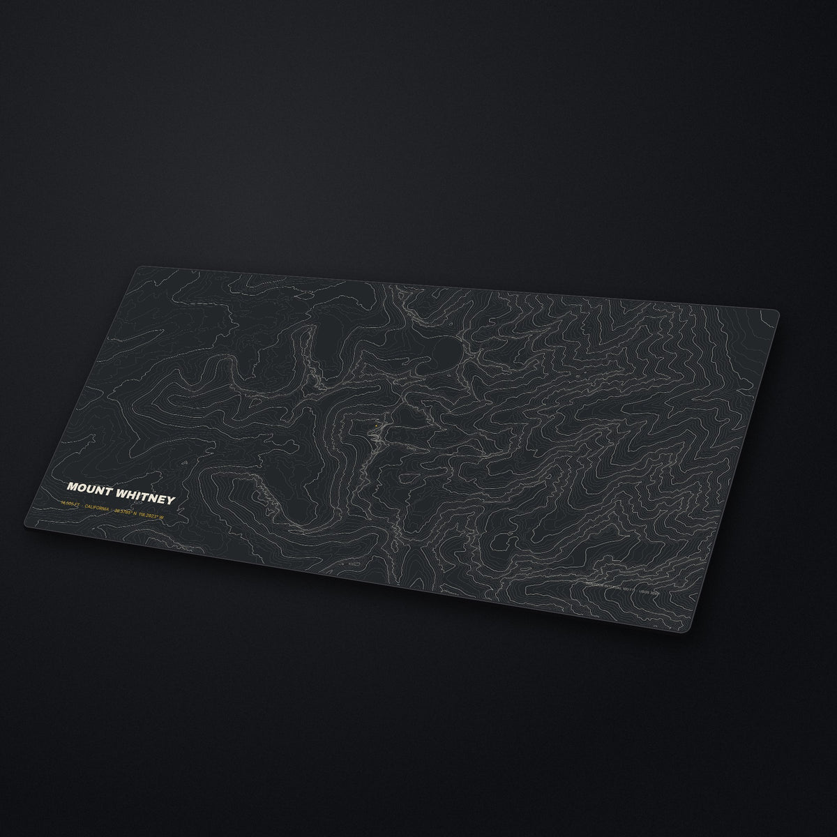 Mount Whitney Topo Desk Mat at an angle on a stone desk