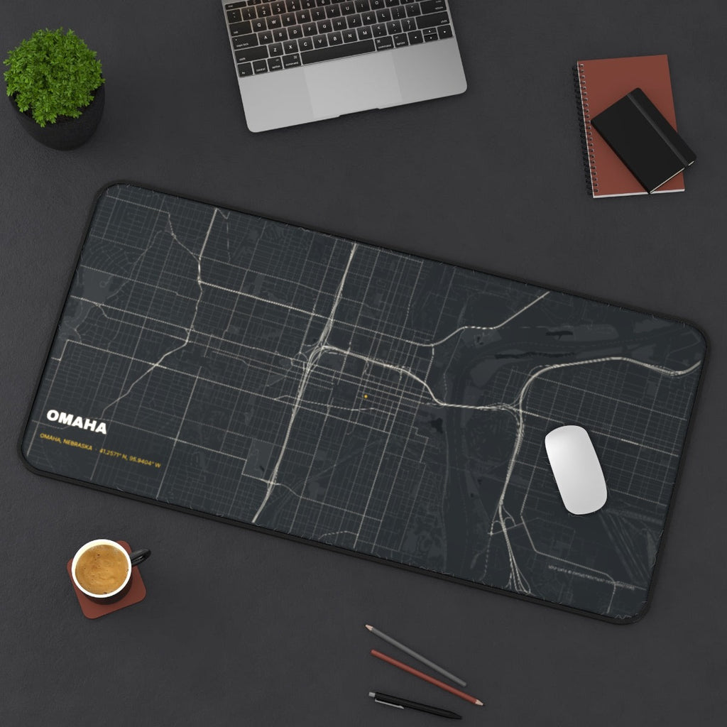 Omaha Street Map desk mat on a desk with a laptop, mouse and coffee cup for scale