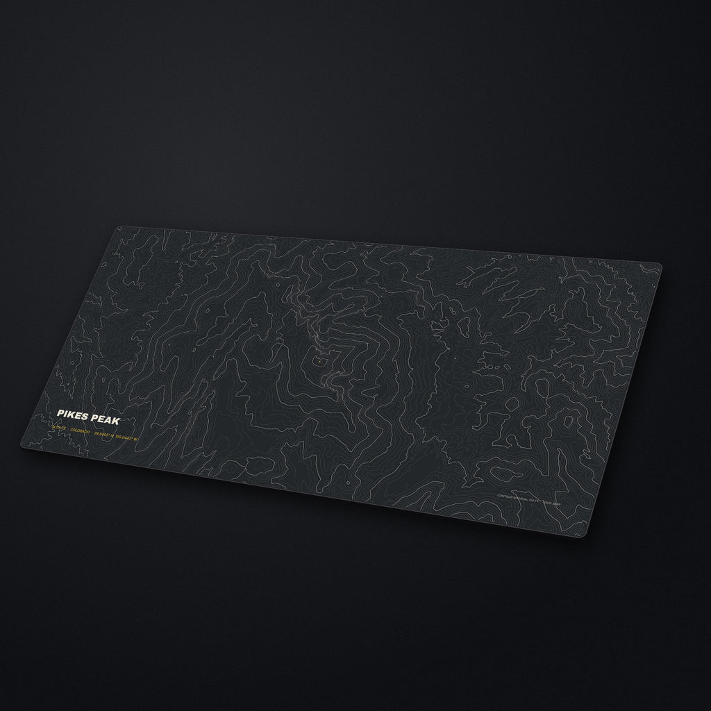 Pikes Peak Topo Desk Mat at an angle on a stone desk