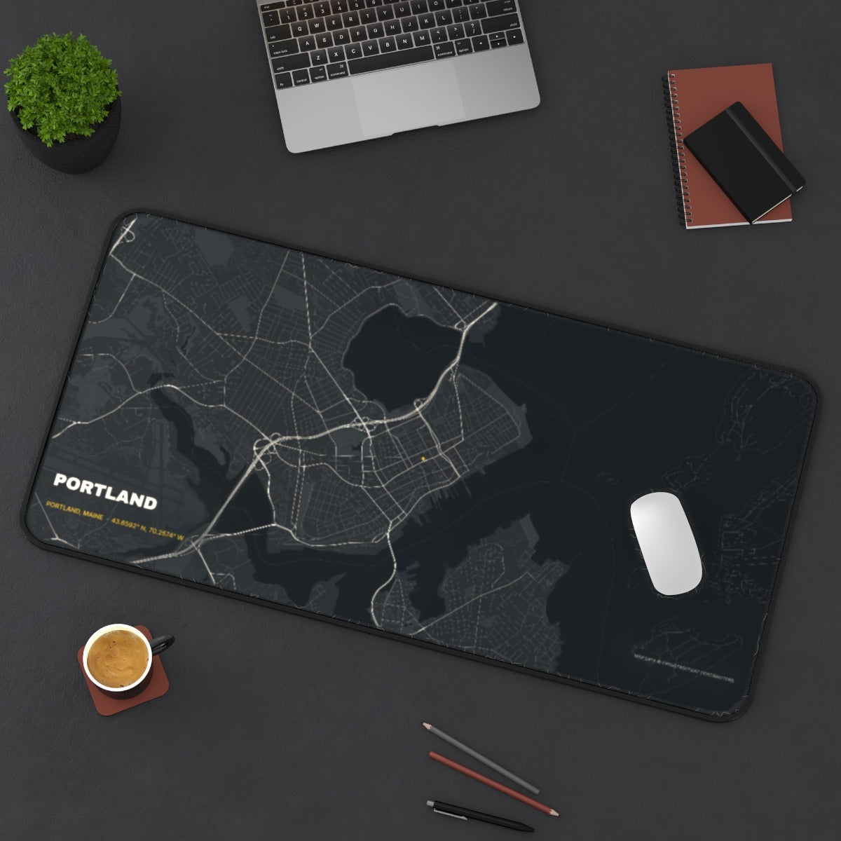 Portland Street Map desk mat on a desk with a laptop, mouse and coffee cup for scale