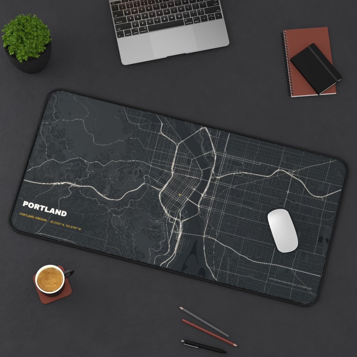 Portland Street Map desk mat on a desk with a laptop, mouse and coffee cup for scale