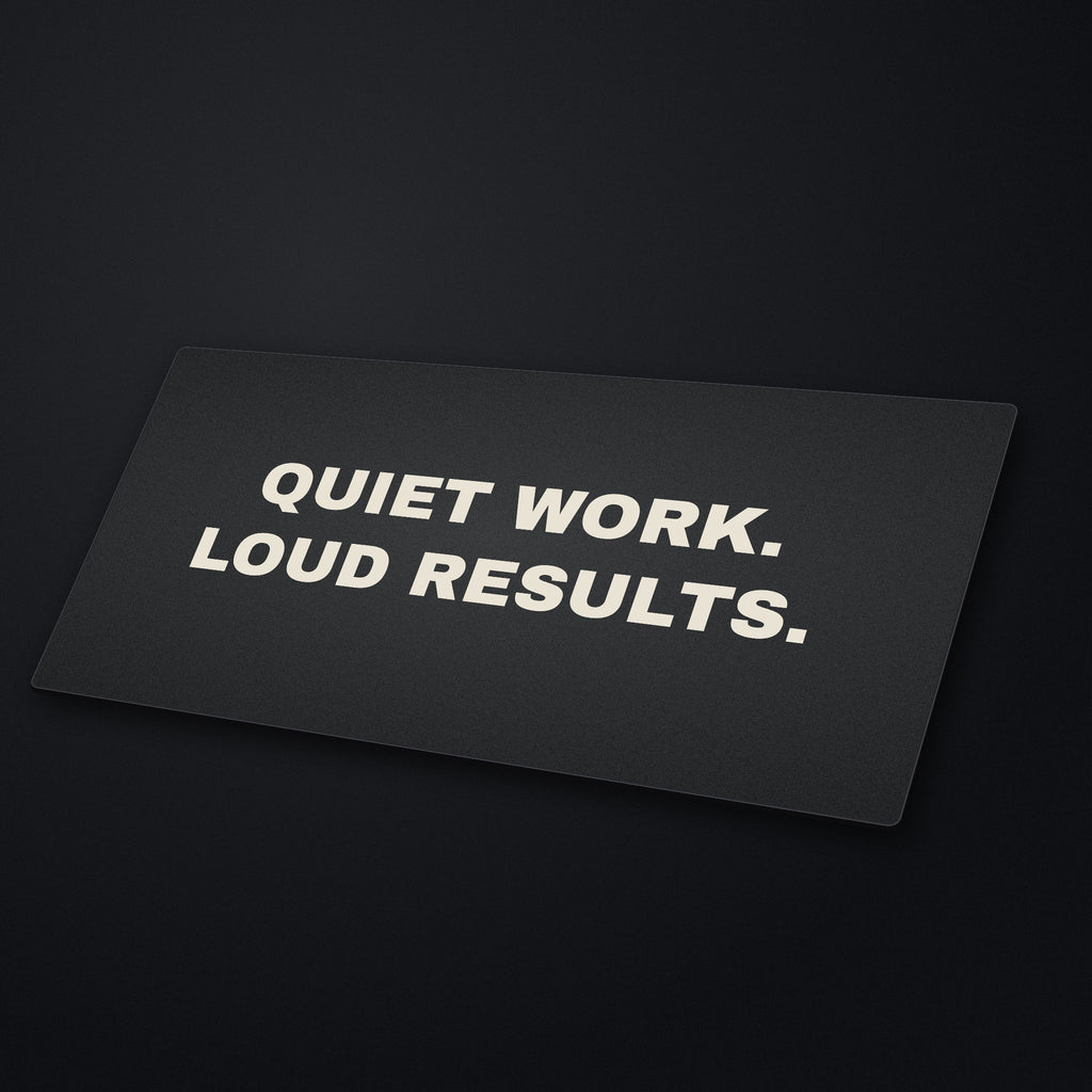Quiet Work Loud Results Desk Mat at an angle on a stone desk