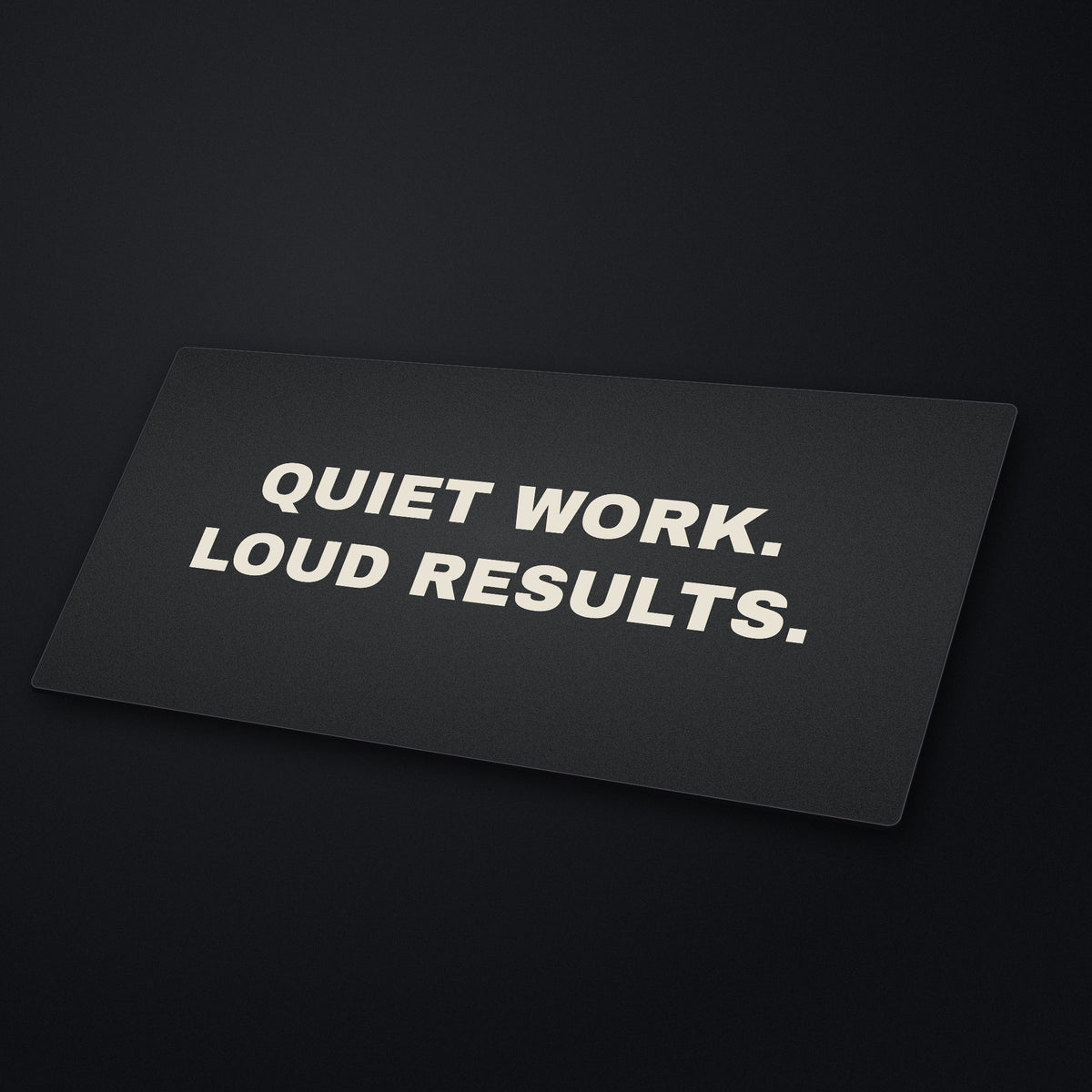 Quiet Work Loud Results Desk Mat at an angle on a stone desk