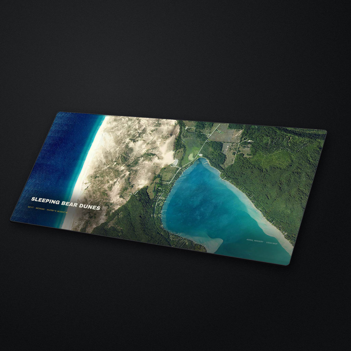 Sleeping Bear Dunes Satellite Desk Mat at an angle on a stone desk