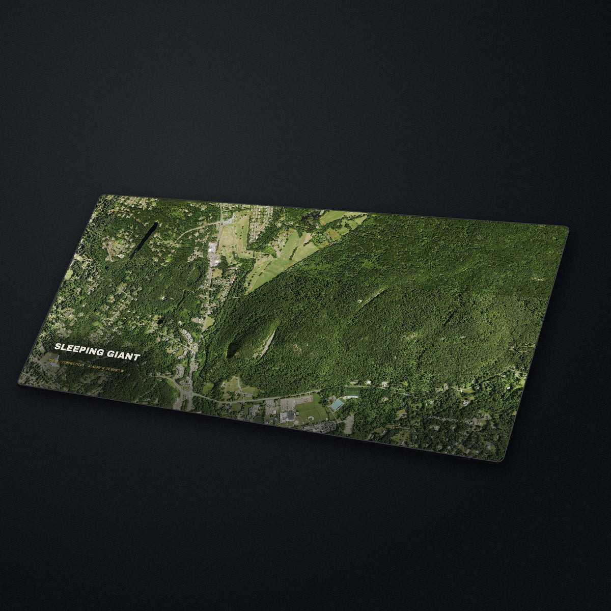 Sleeping Giant Satellite Desk Mat at an angle on a stone desk