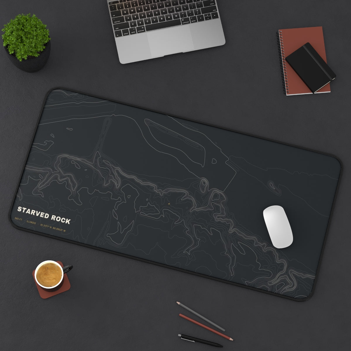 Starved Rock Topo desk mat on a desk with a laptop, mouse and coffee cup for scale