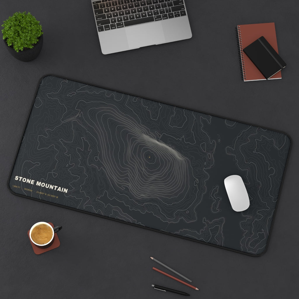 Stone Mountain Topo desk mat on a desk with a laptop, mouse and coffee cup for scale