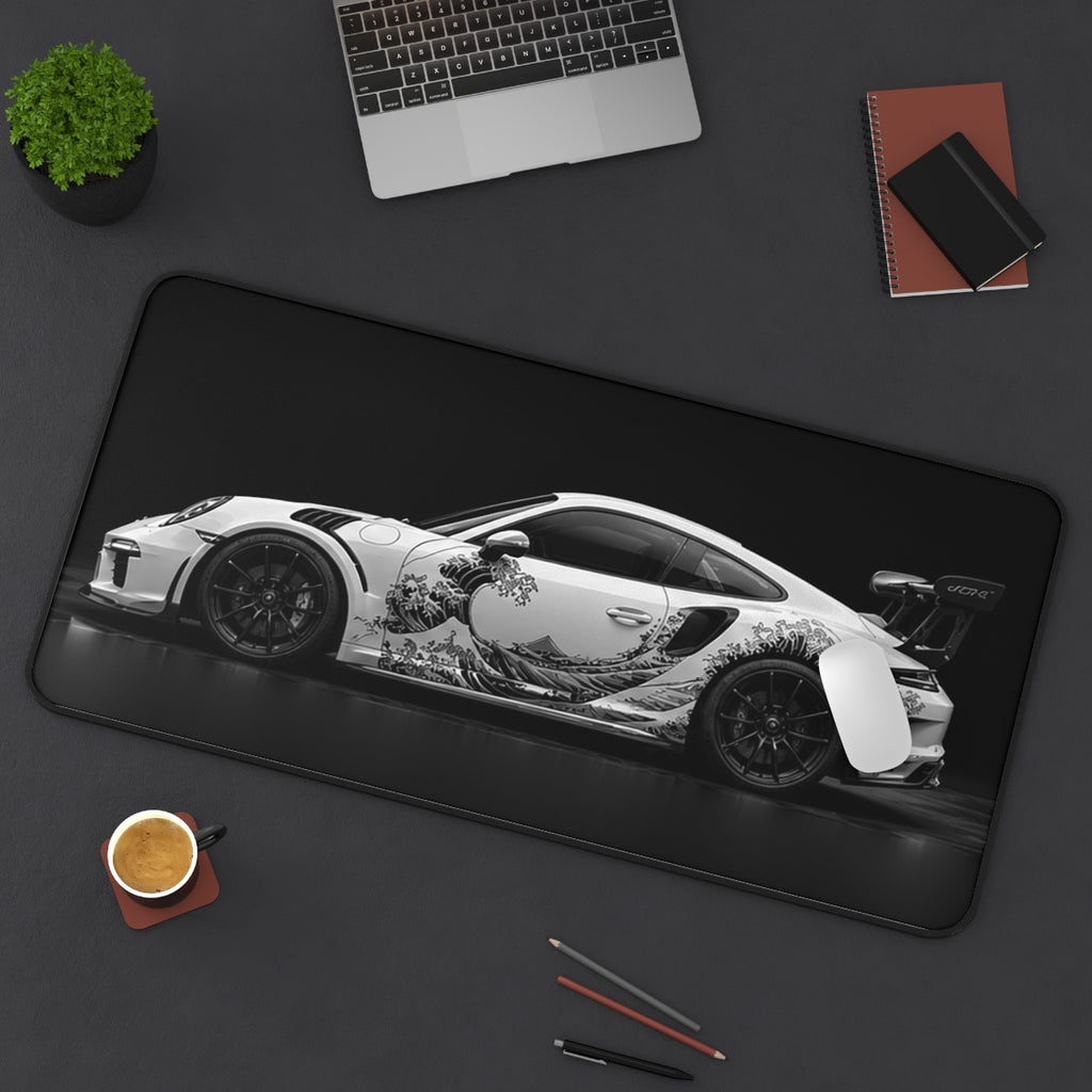 Black White Wave desk mat on a desk with a laptop, mouse and coffee cup for scale