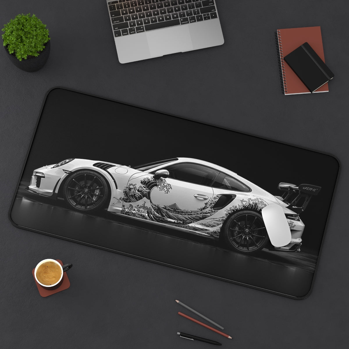 Black White Wave desk mat on a desk with a laptop, mouse and coffee cup for scale