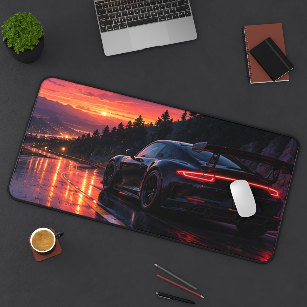 Twilight Mountain Road desk mat on a desk with a laptop, mouse and coffee cup for scale