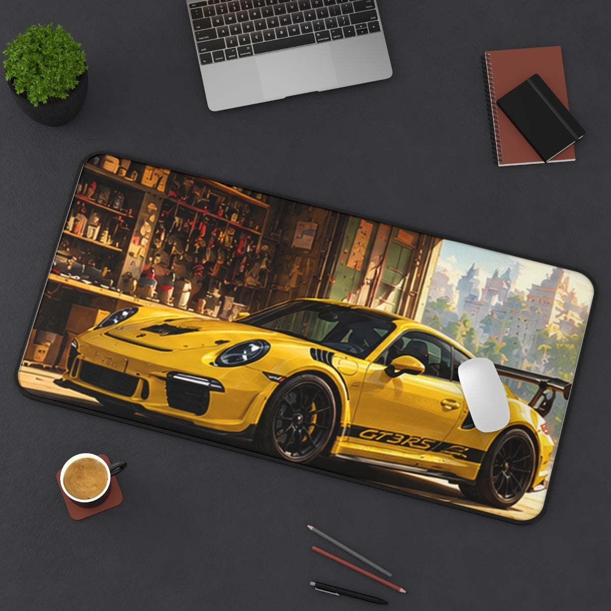 Yellow Workshop desk mat on a desk with a laptop, mouse and coffee cup for scale